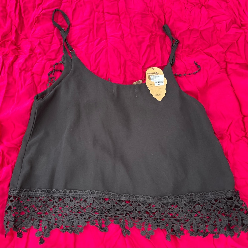 Beautiful summer top. New with tags. 100% polyester. Spaghetti straps.